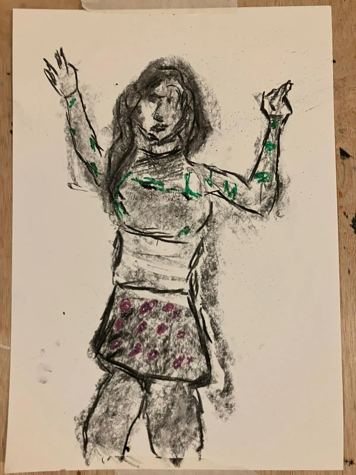 Charcoal figure with raised arms