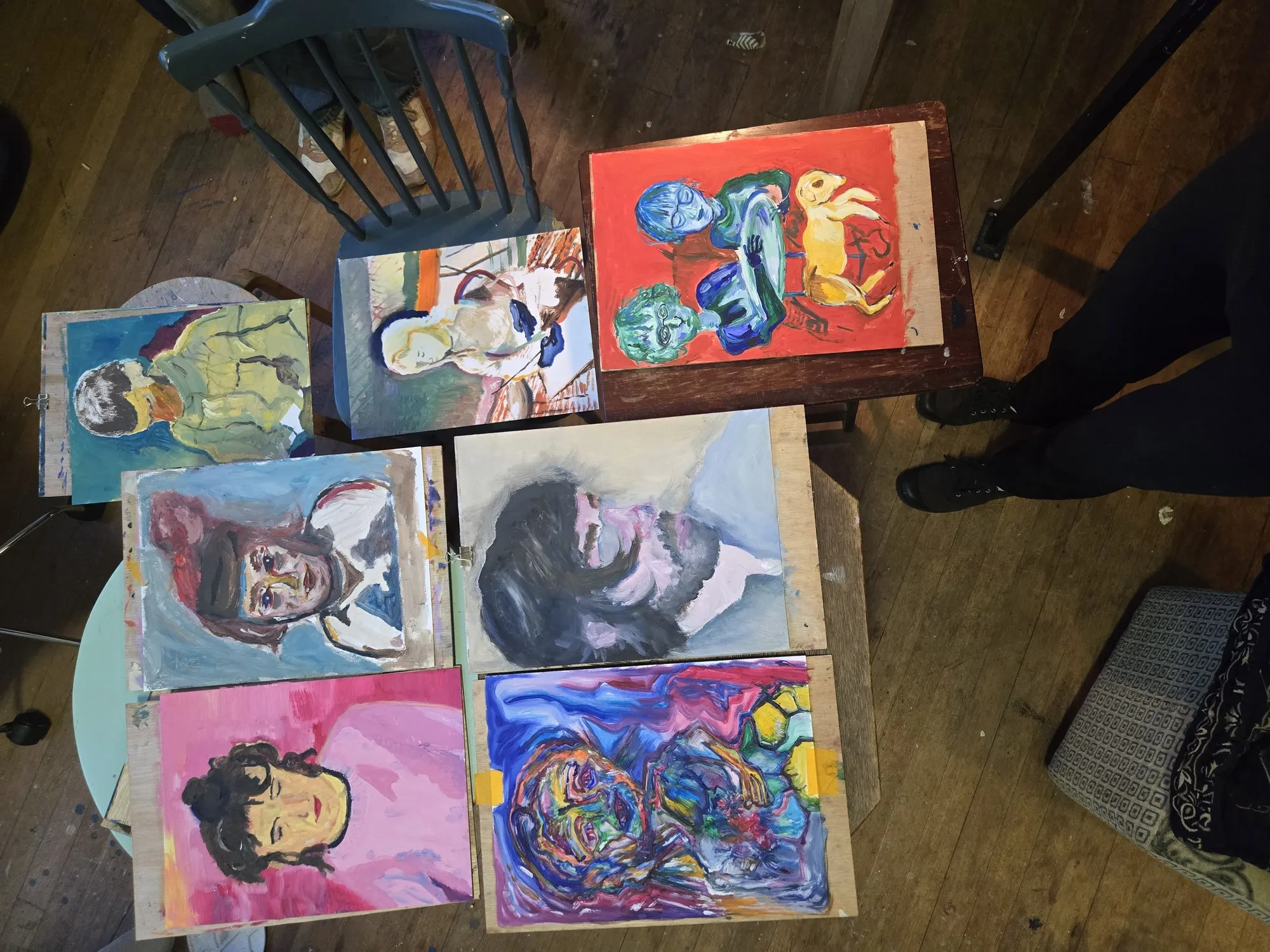 Painted portraits laid out on the floor